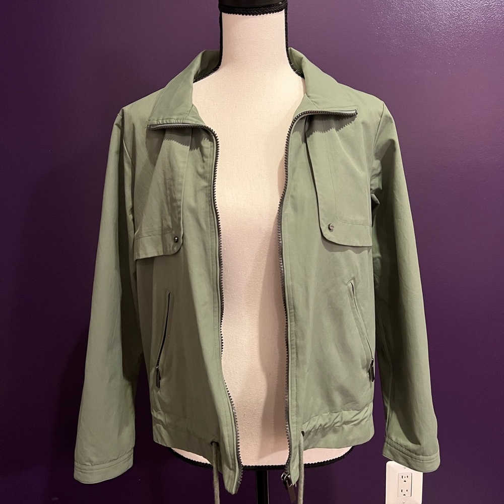 Sage green jacket with grey striped interior